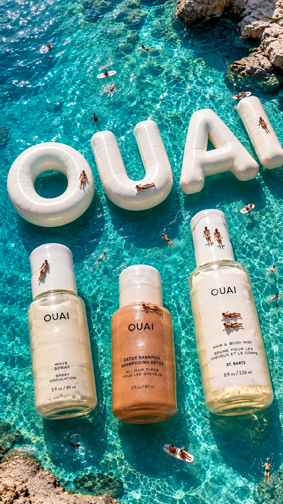 Giant OUAI haircare bottles floating in a bright blue Mediterranean cove